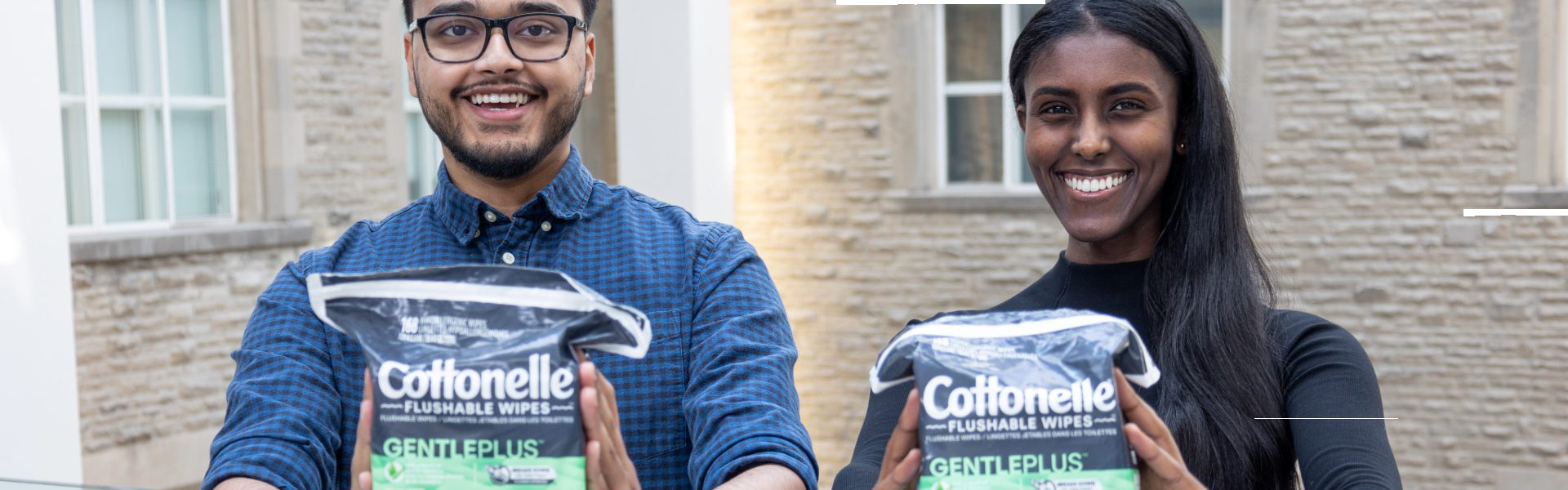 Students pose with packages of flushable wipes